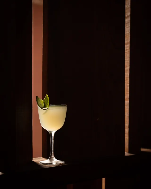 A sage-leaf daiquiri against the adobe wall at Amado, Burlingame