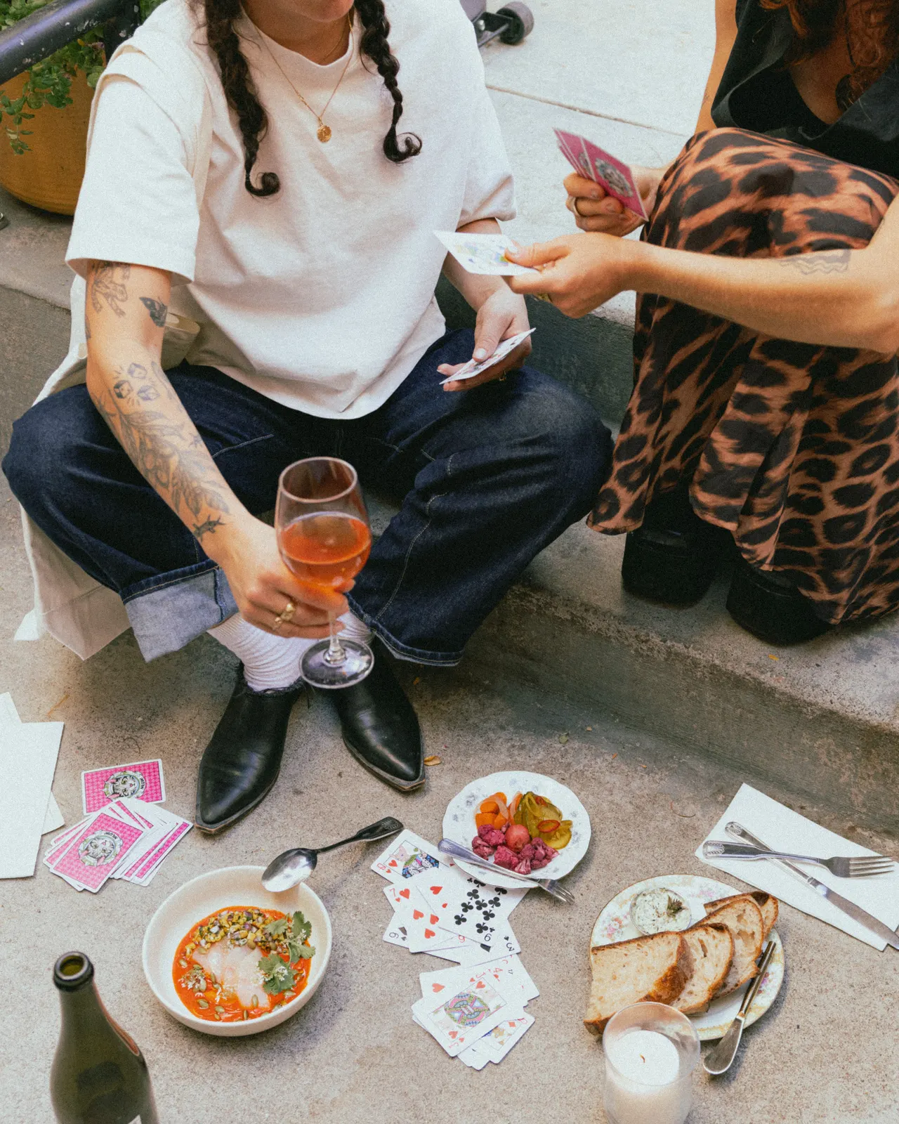 Guests on the curb with a spritz, cards and small plates outside The Black Cat, Livermore