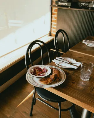 A window table set with a plate and a glass at The Black Cat, Livermore