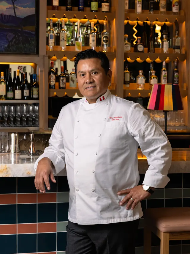 The chef at his bar in dress whites at Casa Sofia, San Francisco