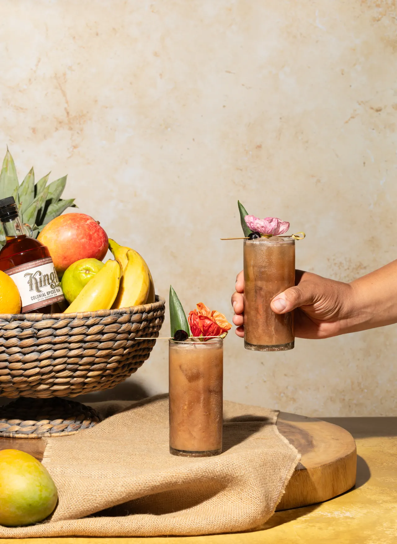 A cocktail raised over the fruit basket, from Caribbean Cocktails for Ten Speed Press
