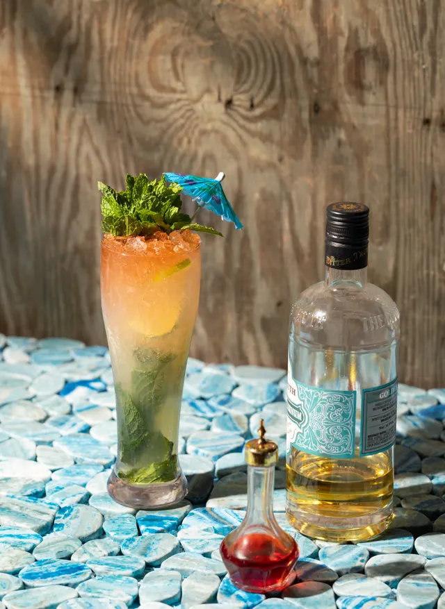 A mojito and its bottle on broken tile, from Caribbean Cocktails for Ten Speed Press