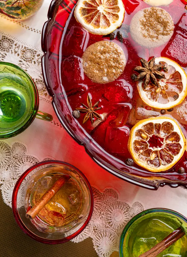 A red punch bowl from above with dried citrus and star anise, from Caribbean Cocktails for Ten Speed Press