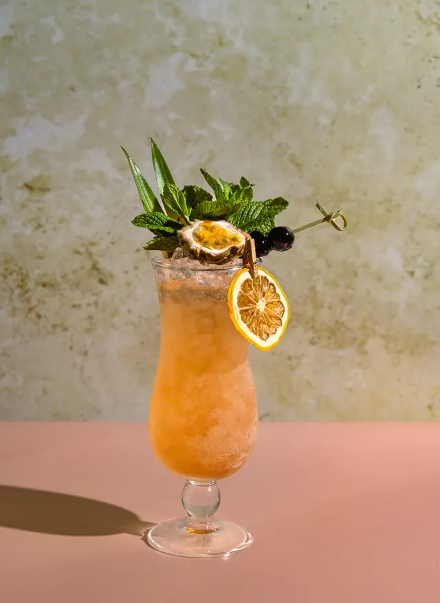 A mint-crowned collins on peach, from Caribbean Cocktails for Ten Speed Press
