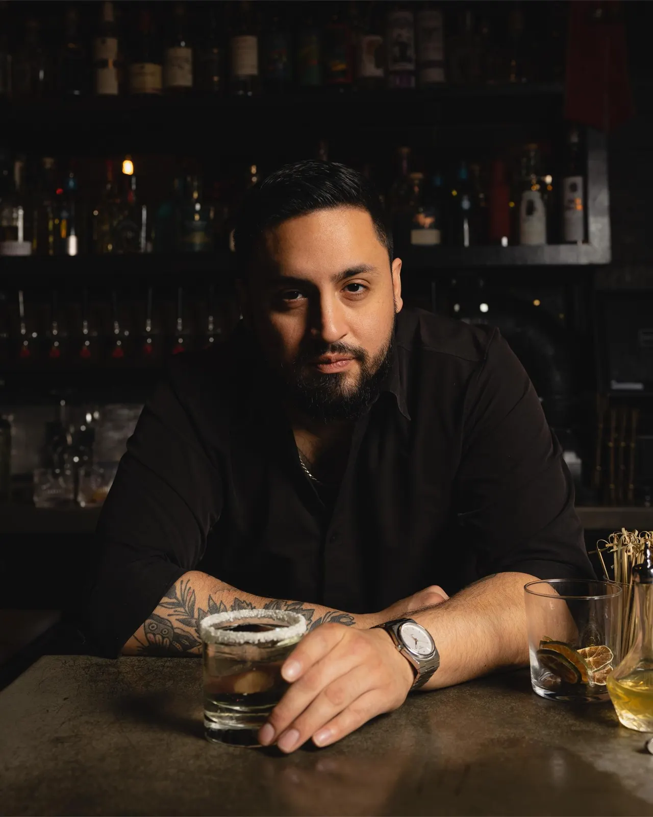 The bar manager at his rail in low light at Distrito Federal, Campbell