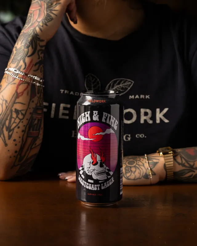 The Milk & Fire can against the branded tee for Fieldwork Brewing, San Leandro
