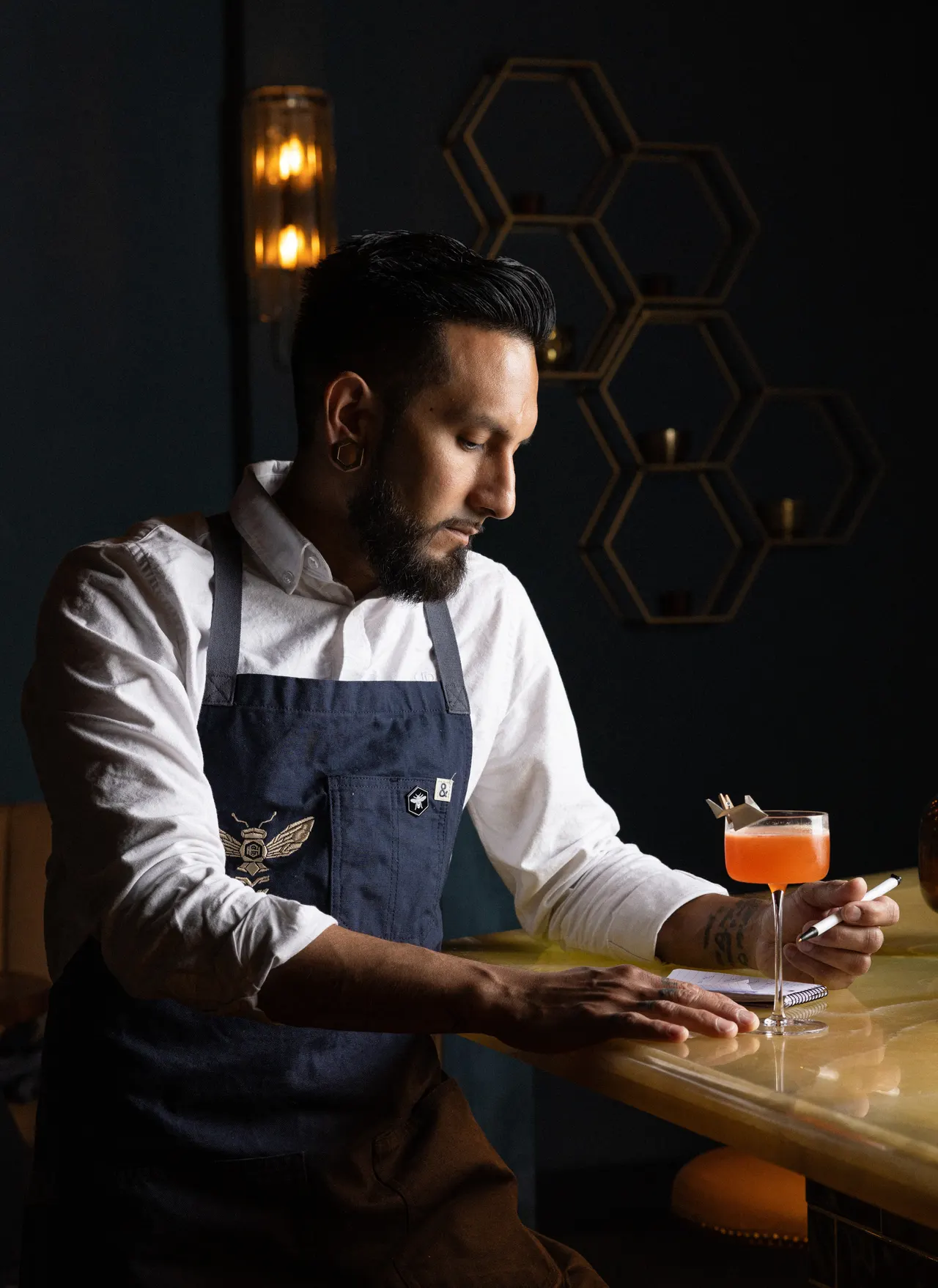 The bartender studying his build at Honeycomb Cocktail Lounge, Livermore