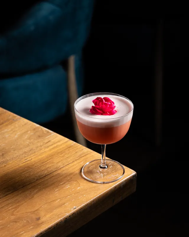 A rose-topped sour in the spotlight at Honeycomb Cocktail Lounge, Livermore