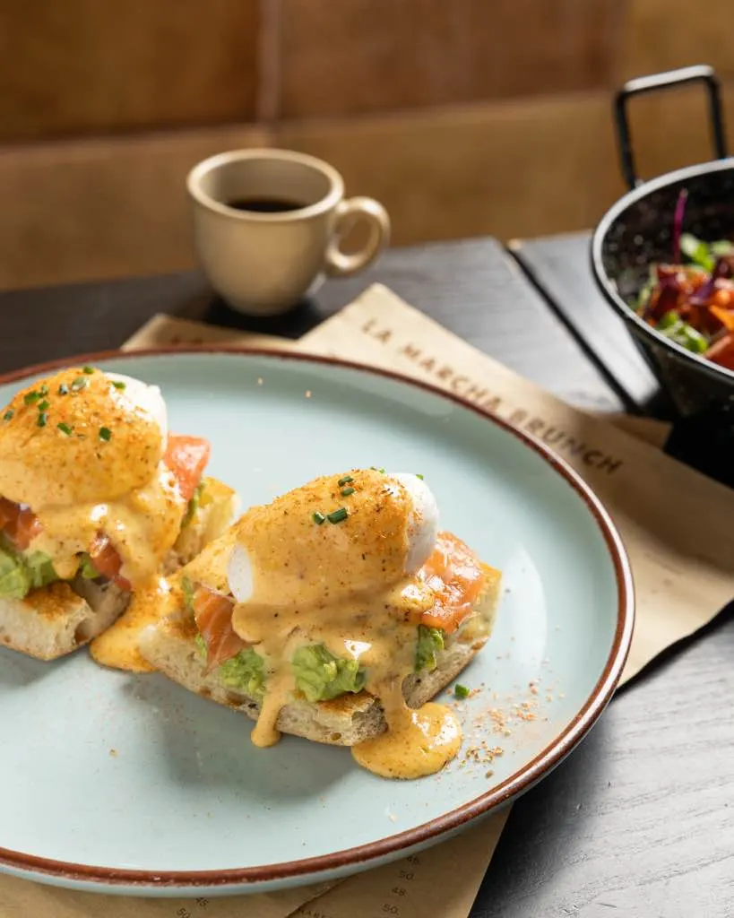 Plated eggs benedict with salmon and avocado on toast at La Marcha, Berkeley, brunch service