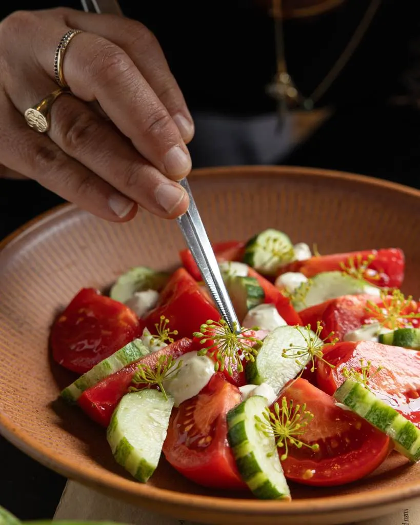 Tomato and cucumber salad plated close-up on a dark ground at La Marcha, Berkeley
