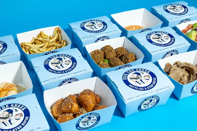 Branded delivery boxes gridded on blue for the Nick the Greek menu program