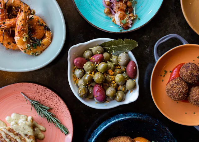 Tapas plates styled overhead as one consistent set - recipe photography by Lemonad Media