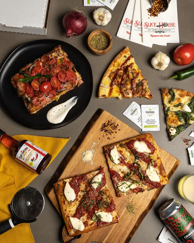Sicilian slices and branded hot honey flat-laid for Slice House by Tony Gemignani