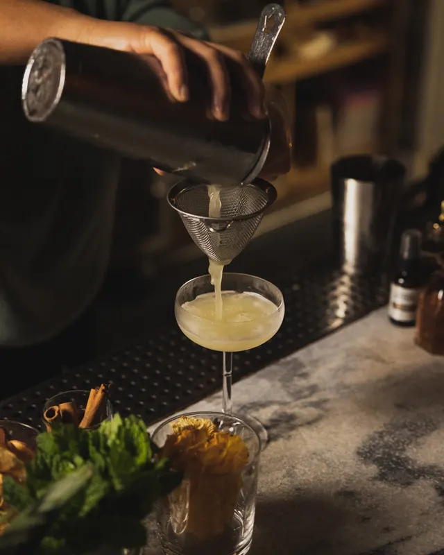 A strained pour into a chilled coupe behind the bar at Sons of Liberty Alehouse, San Leandro