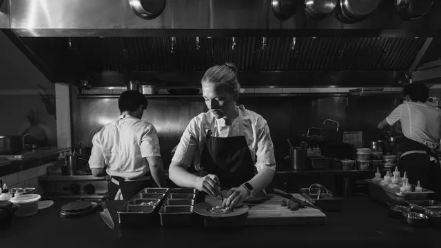 Chef Sara plating in black and white at Sorrel, San Francisco