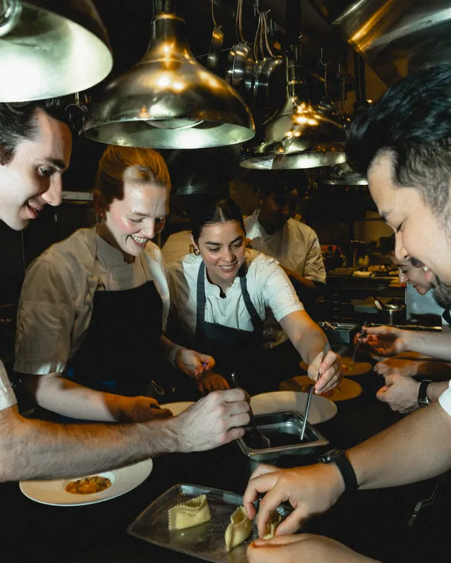 The kitchen team plating together at the pass at Sorrel, San Francisco