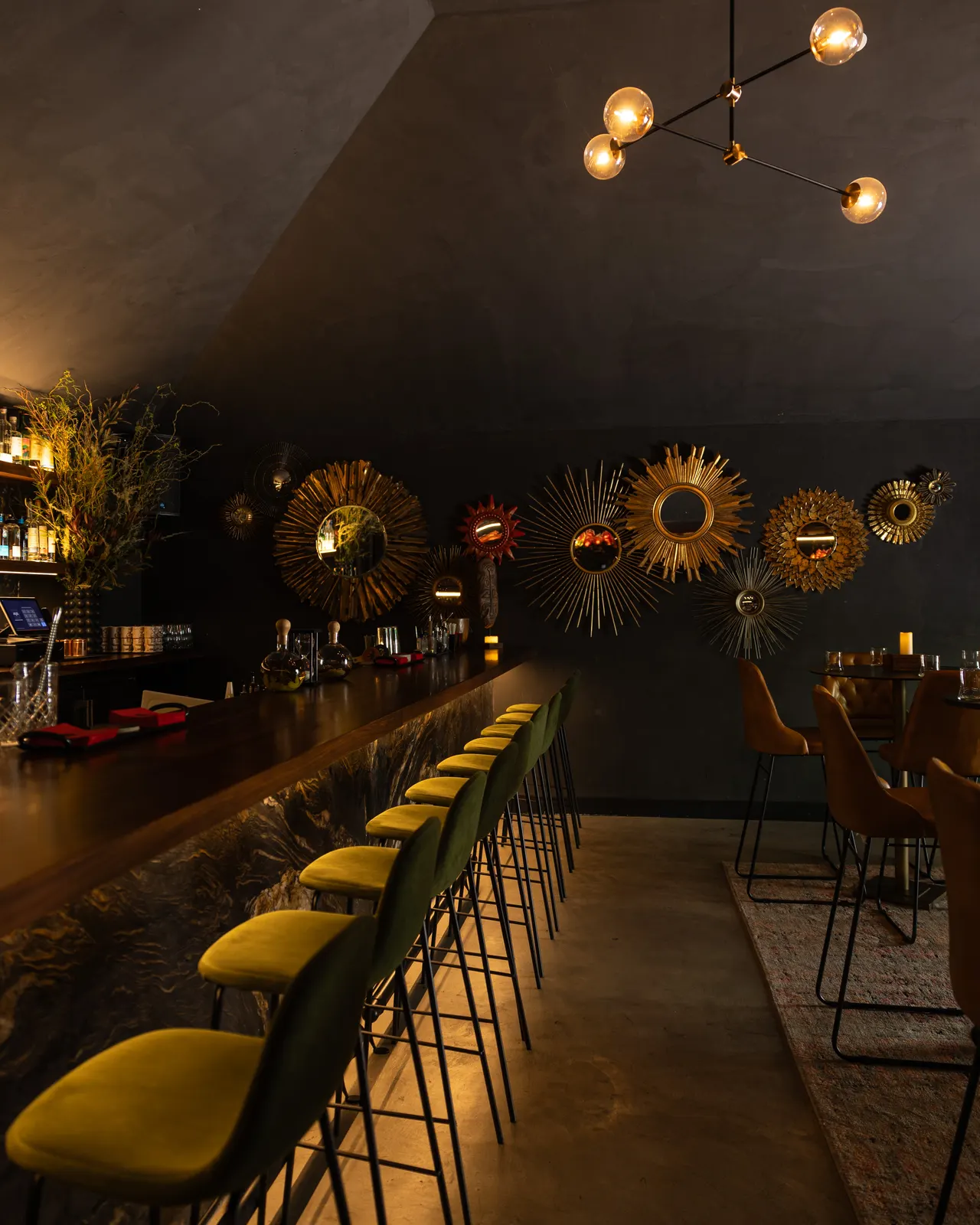 Mustard bar stools and sunburst mirrors down the rail at S.Bar, San Jose