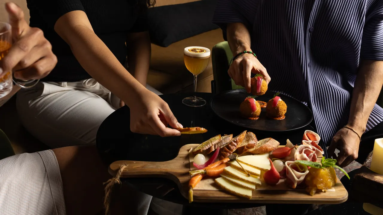 A charcuterie board and croquetas shared across the low table at Suspiro, Santana Row, San Jose