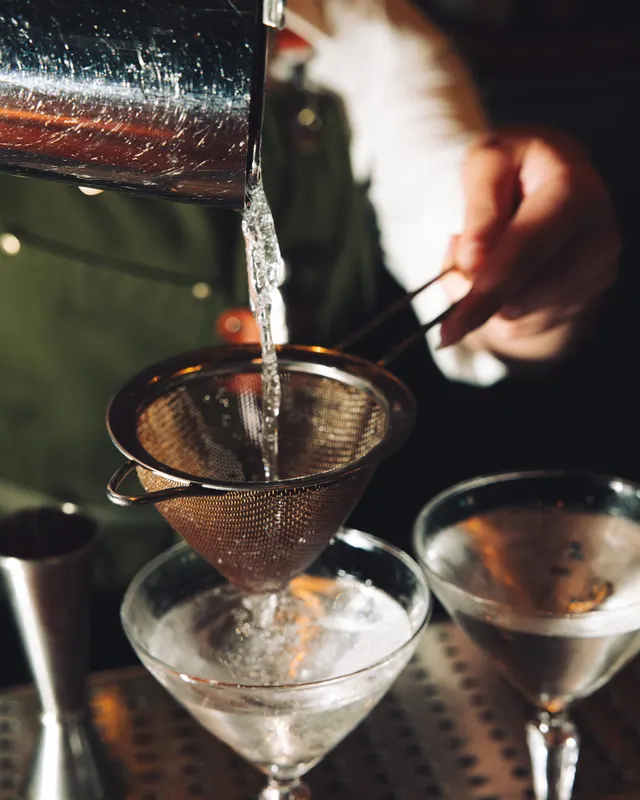 A cocktail double-strained into twin coupes at Suspiro, Santana Row, San Jose
