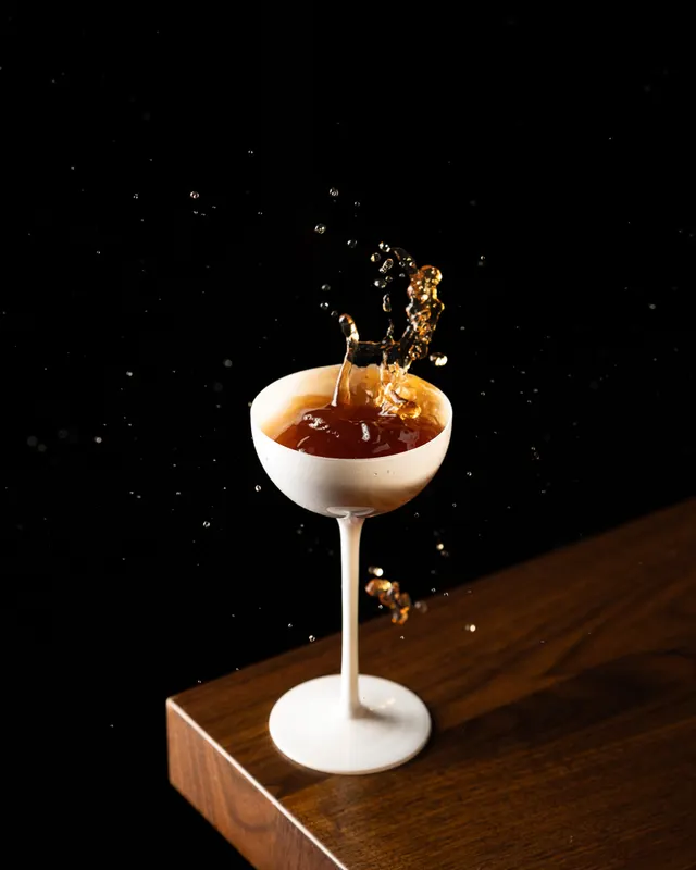 A splash caught leaving the coupe mid-pour at Suspiro, San Jose