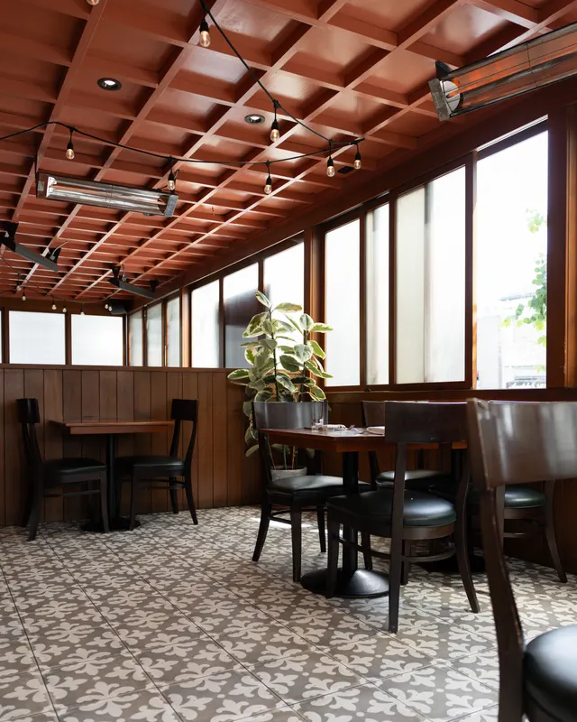 The dining room under a red slatted ceiling at The Wolf, Oakland