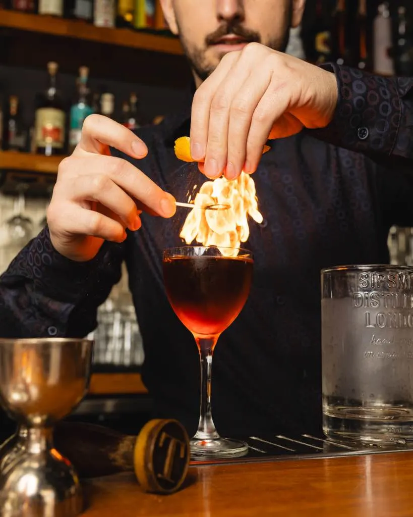 An orange peel flamed over a negroni at Town Tavern, Alameda