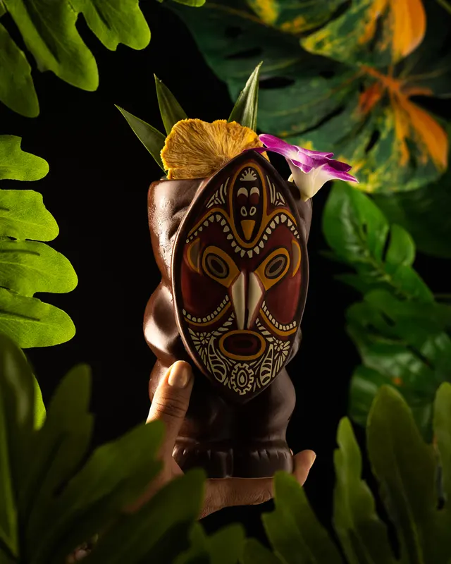 A carved tiki mug with orchid and hibiscus at Trader Vic's, Emeryville